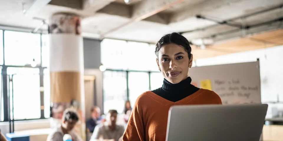 Portrait of a young woman using the laptop in the classroom