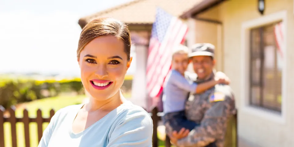 attractive young woman in front of her military family
