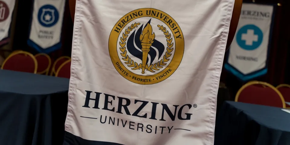 Herzing University banner at graduation