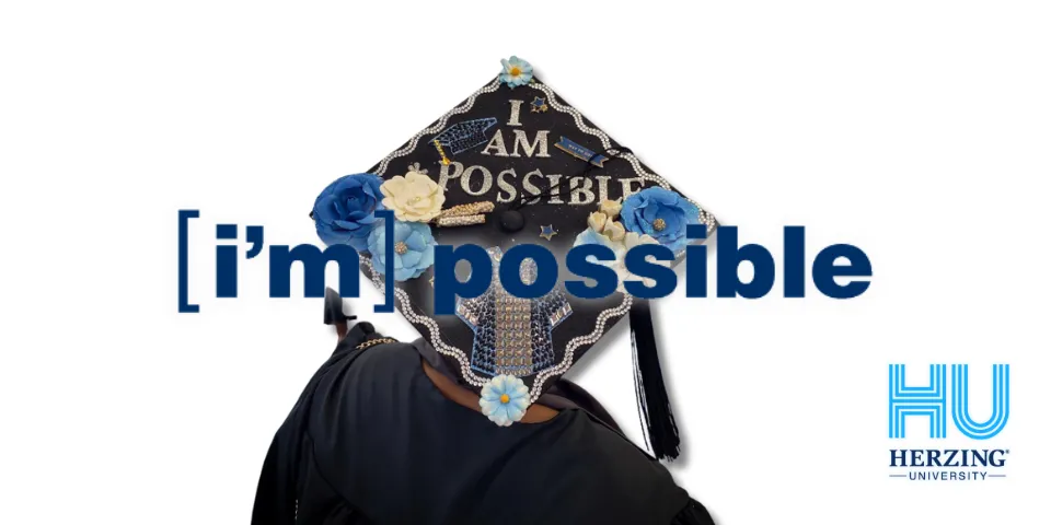 I'm Possible grad cap with Herzing University logo