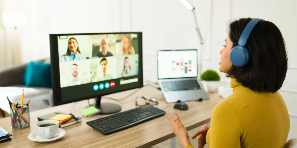 Young entrepreneur attending a virtual meeting with her team while working remotely from home