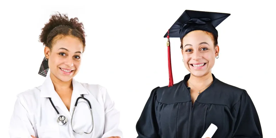 A nursing student smiles while holding her degree in her hand after graduating.