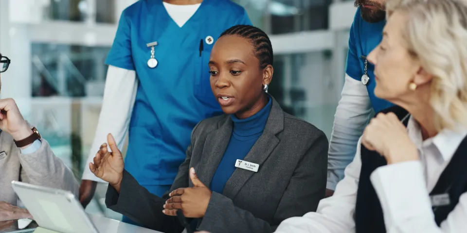 Doctors, nurses or meeting with tablet in hospital for surgery schedule, task delegation or planning. Medical staff, people and feedback with tech for clinic management, healthcare cost and teamwork