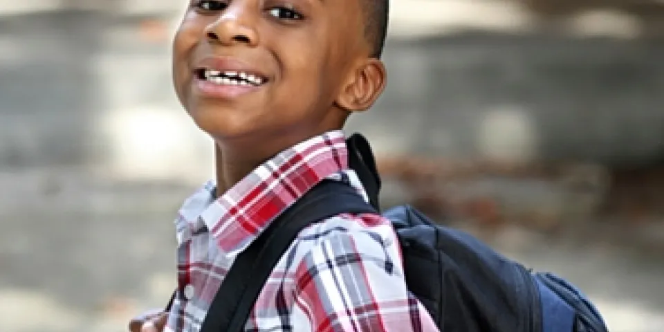 Child carrying new backpack