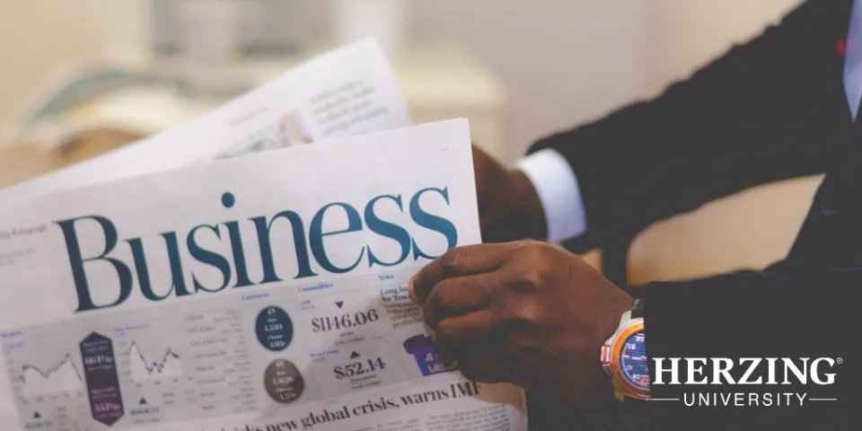 Man wearing watch reading newspaper