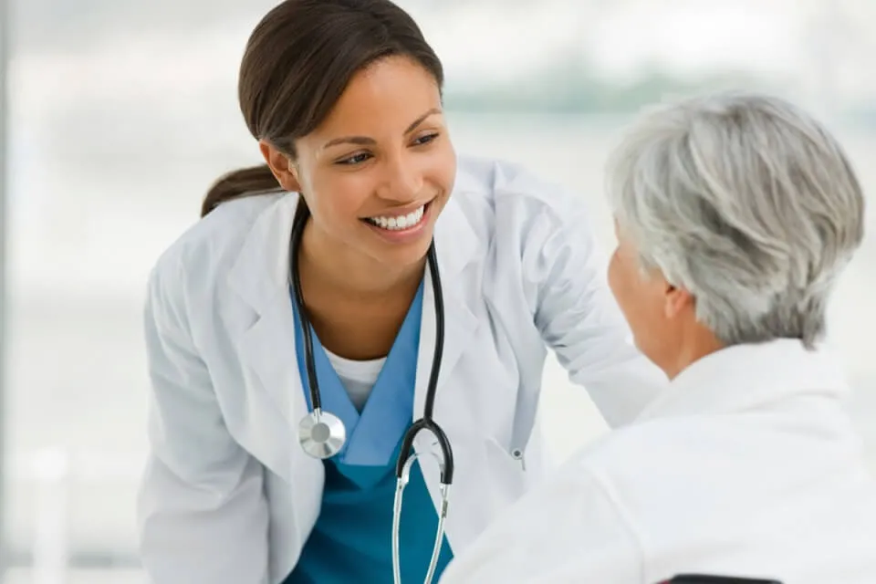 FNP Smiling at Geriatric Patient in Wheelchair