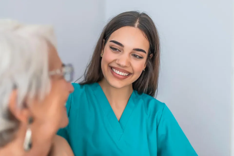 Medical Assistant Smiling with Geriatric Patient