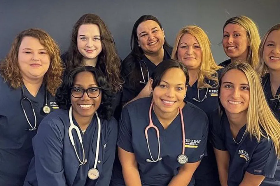 Group of nursing students in scrubs smiling