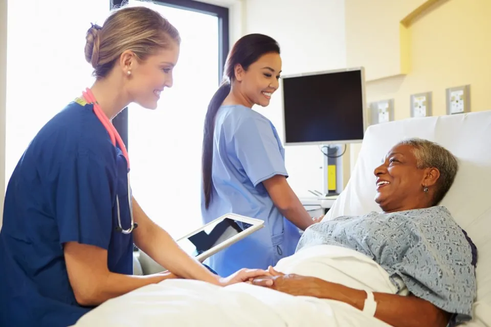 CVICU Cardiac Nurse Speaking with Patient in Hospital Bed