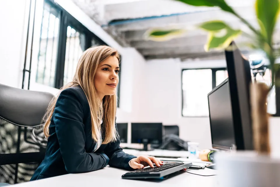 Health Information Technician Smiling at Desk