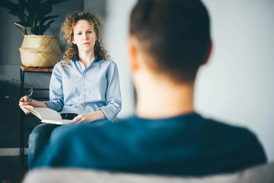 Social Worker Counseling with Client in Office