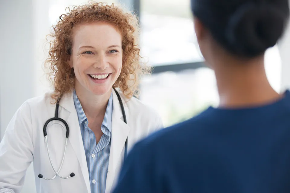 Public Health Nurse Smiling with Patient in Office
