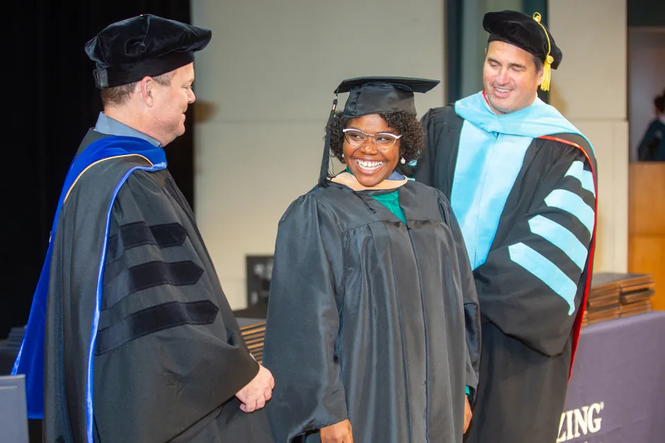 Herzing University Graduate Smiling at Ceremony