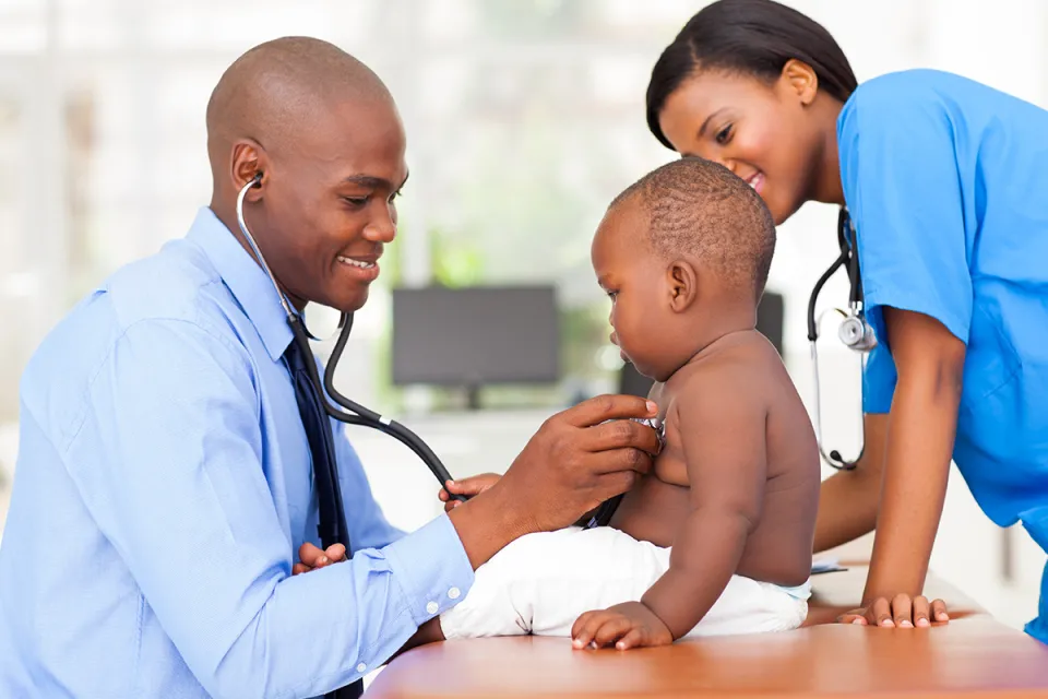 Family Nurse Practitioner Taking Heart Rate of Pediatric Patient