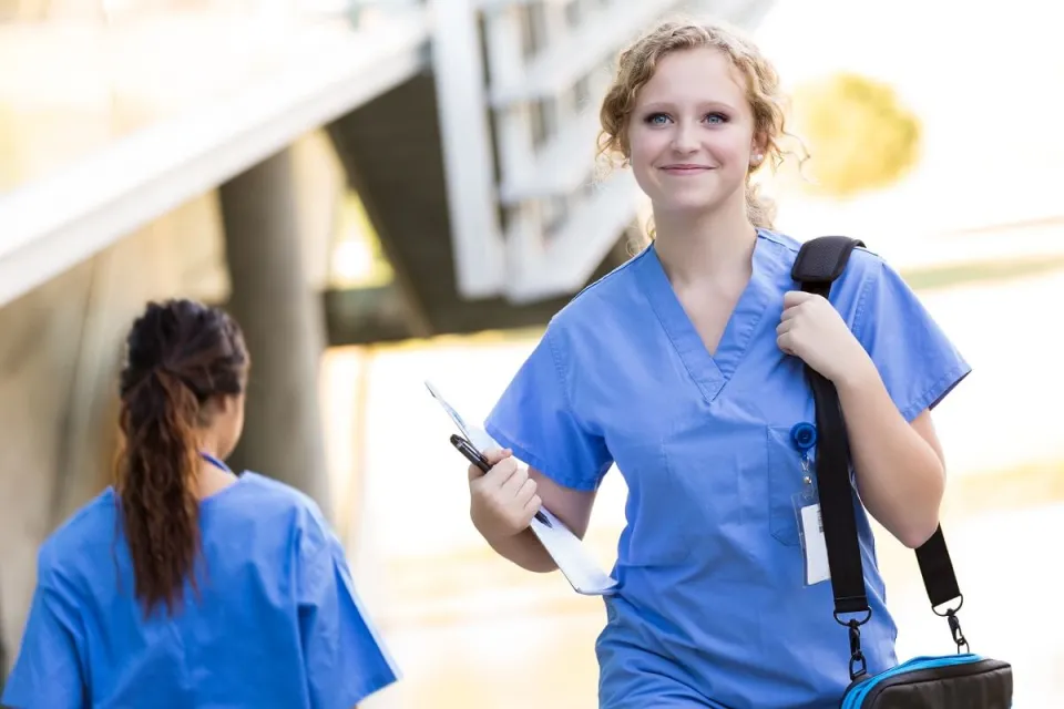 Smiling CNA Going to Nursing School to Become an RN