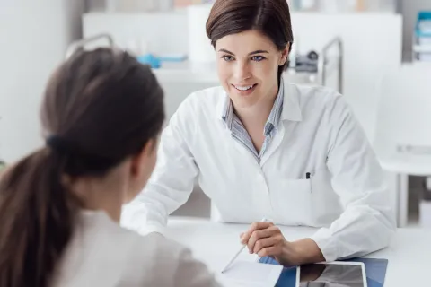 Nurse Practitioner with DNP Speaking with Patient