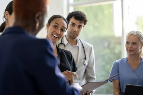 /sites/default/files/styles/fp_640_393/public/2026-05/nurse-smiling-with-team.webp?h=5d999566&itok=kVjLSjVd